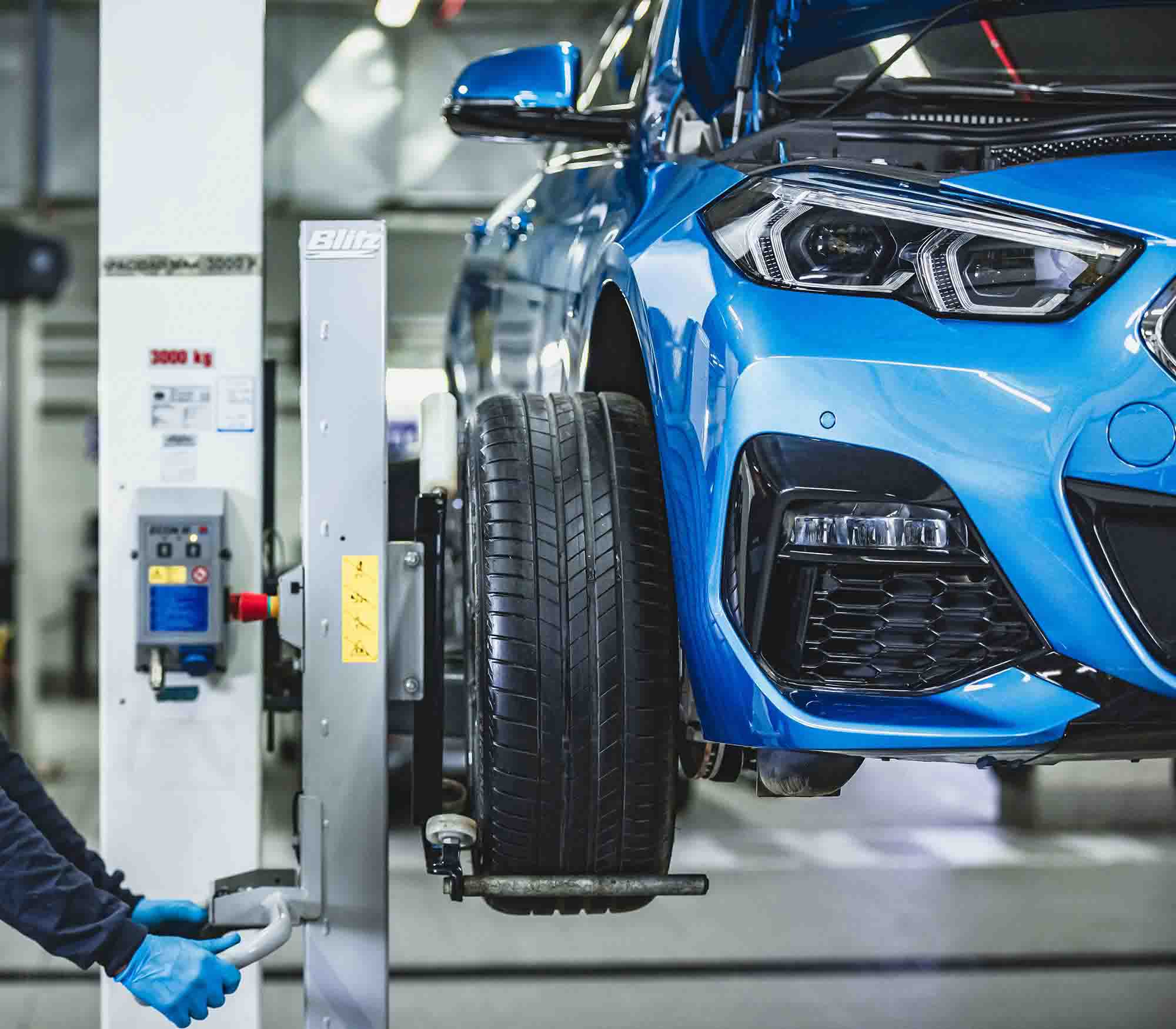 Blue BMW in shop being repaired – Advanced auto solutions Blue BMW in shop being repaired - Advanced auto solutions