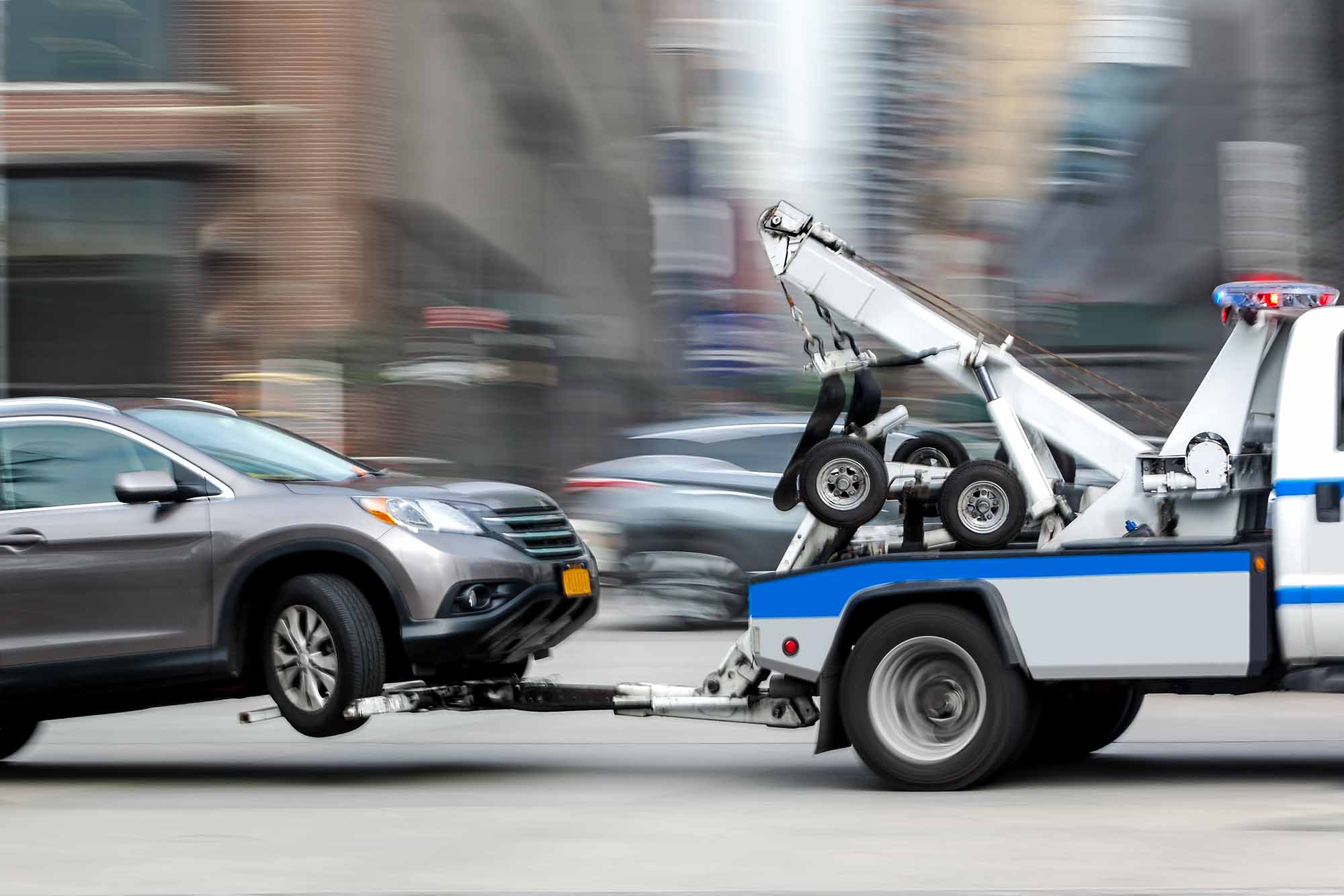 Grey SUV on T-Truck being towed – Advanced Auto Solutions Towing Services Grey SUV on T-Truck being towed - Advanced Auto Solutions Towing Services