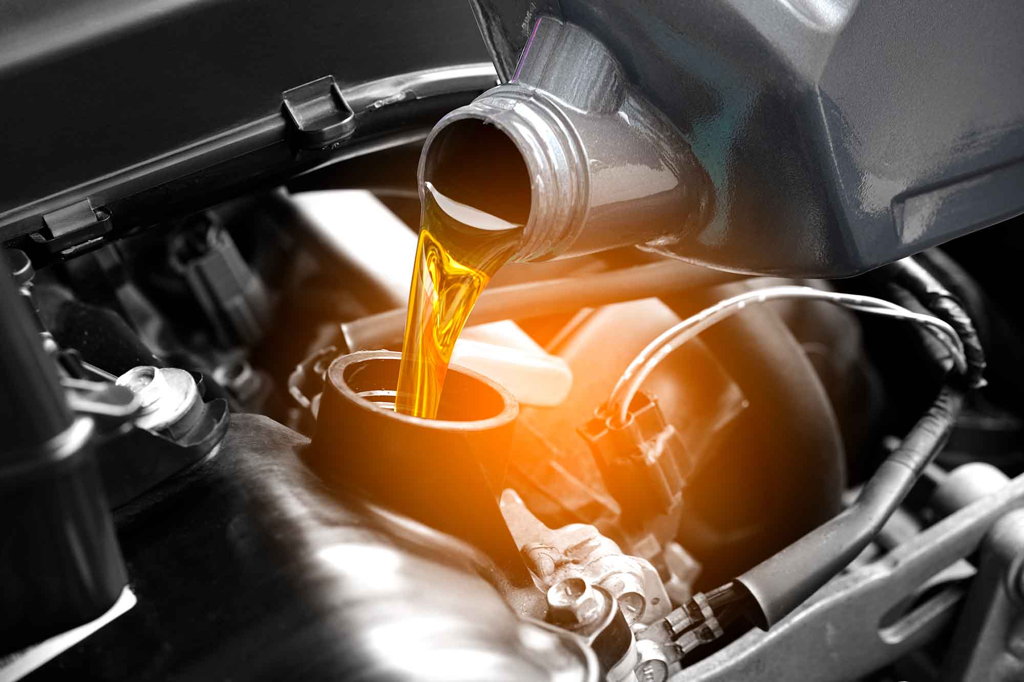 Oil Being poured into motor - Oil Change Service - Advanced Auto Solutions Auto Repair Services